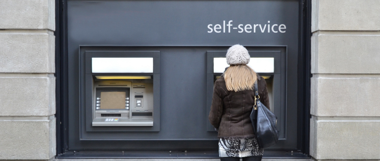 person standing at ATM