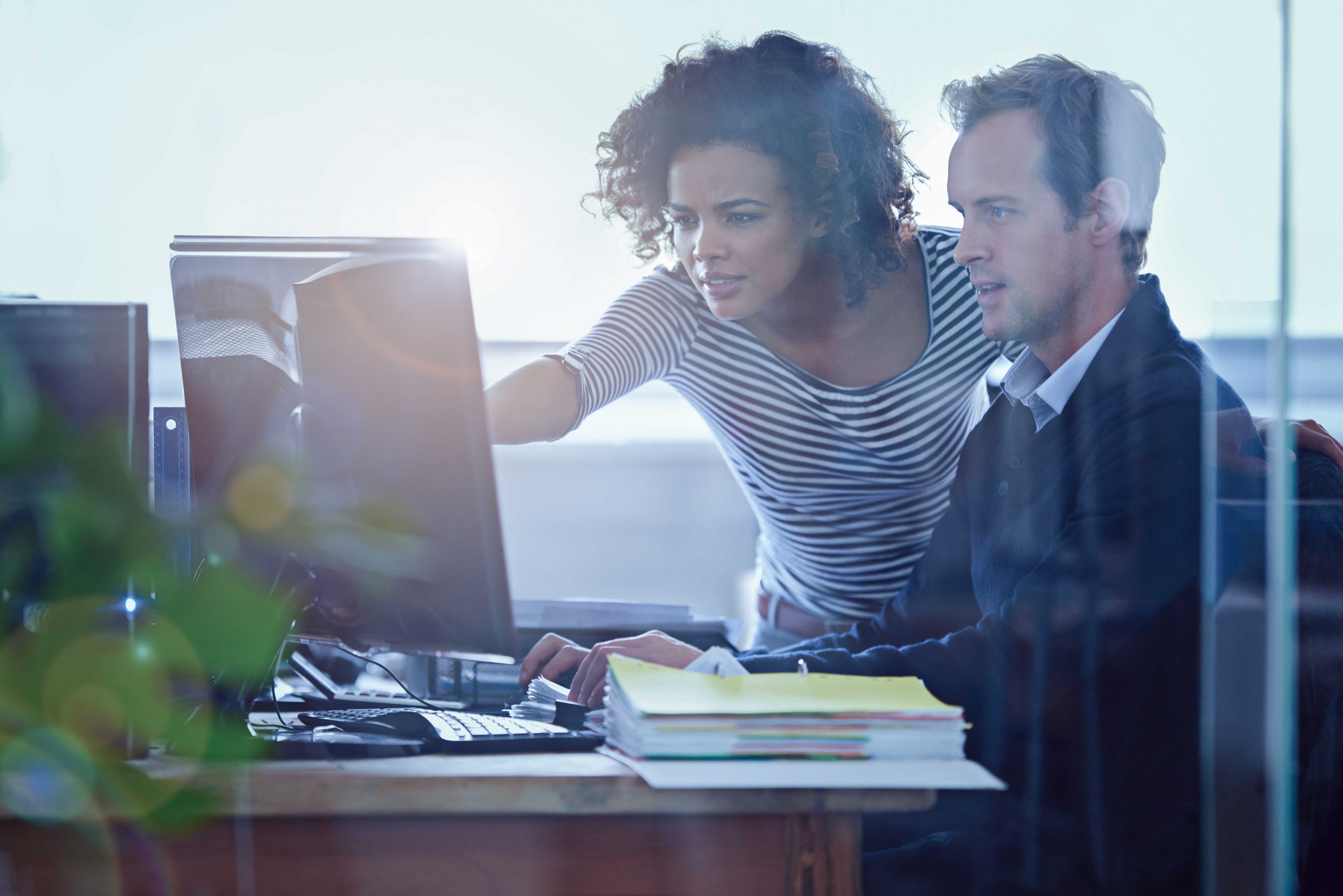 Accounts Payable Automation - Cropped shot of two colleagues working together in the office