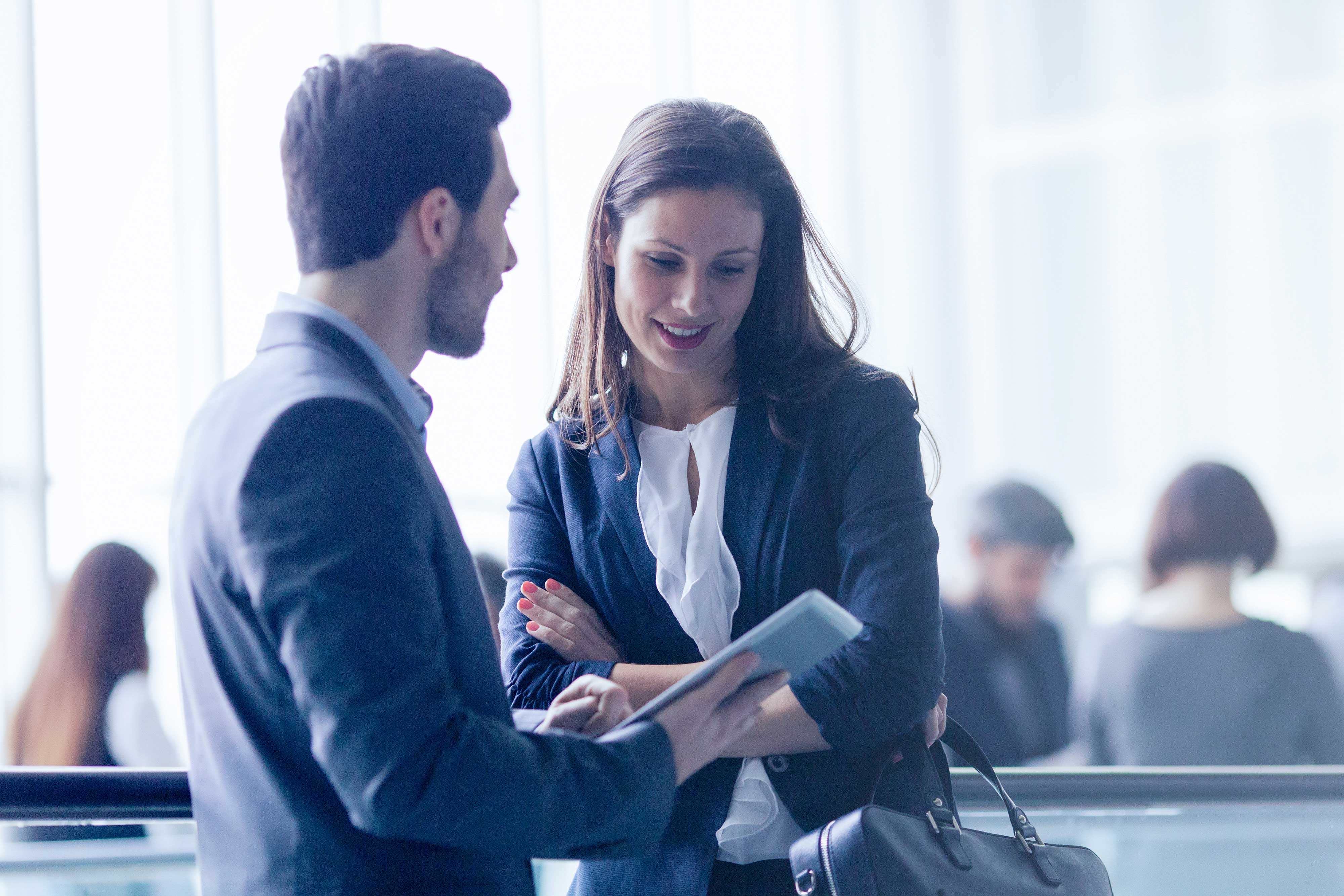 Accounts Payable Automation - A couple of young business people talking in the lobby