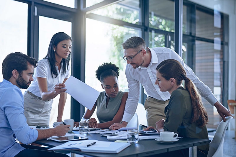 Procurement team collaborating over documents